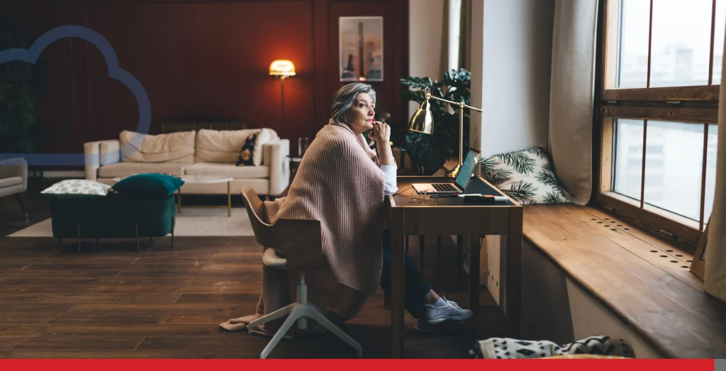 Thoughtful mature woman sitting at table with laptop Stock Photo, ft. apartment & blank screen - Envato