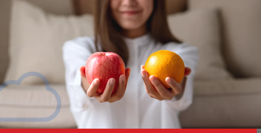 Closeup image of a young woman holding and showing an orange and a red apple Stock Photo, ft. adult & asian - Envato