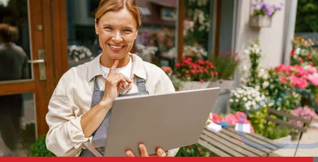 Smiling florist working on laptop and taking online orders in store and looking at camera Stock Photo, ft. adult & beautiful - Envato