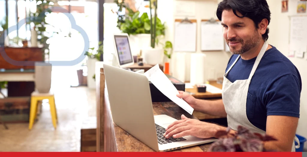 Male Sales Assistant Working On Laptop Behind Sales Desk Of Florists Store Stock Photo, ft. 30s & ambition - Envato