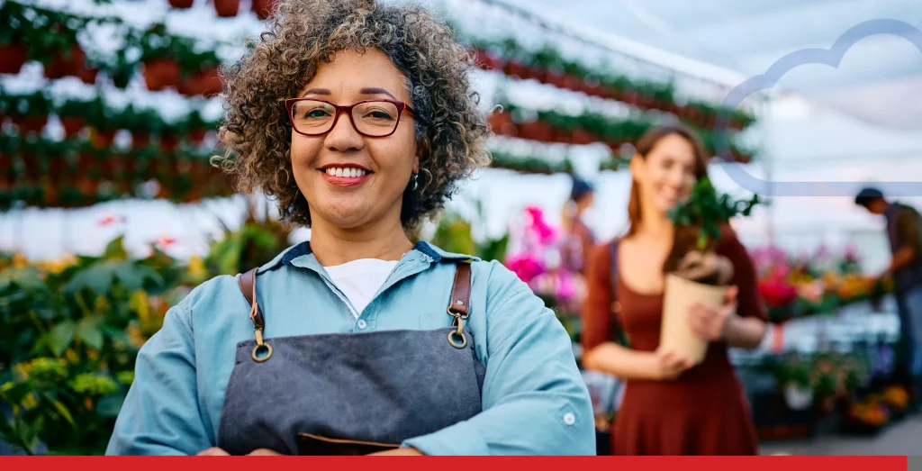 Confident plant nursery owner with her customer in the background. Stock Photo, ft. small business owner & wifi - Envato