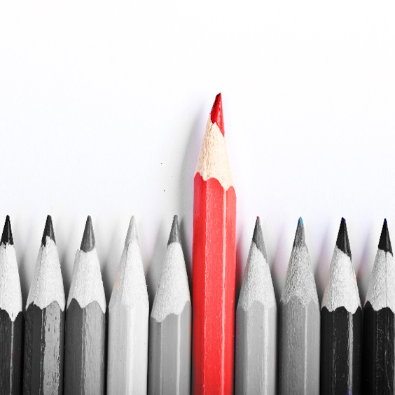 row of gray colored pencils with one orange pencil